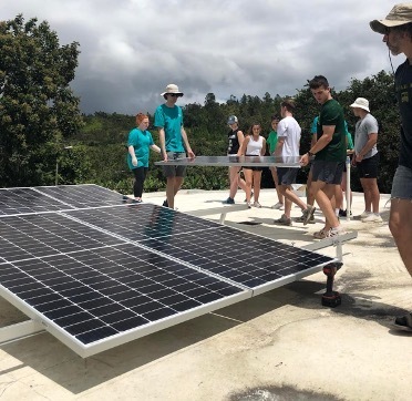 Student setting up solar panels in Puerto Rico